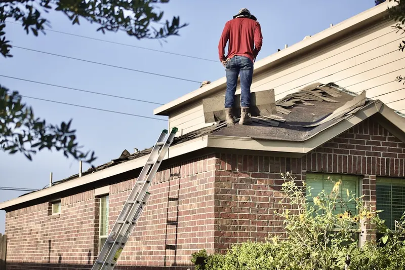 Professional roofer working on a residential roof in Coalport
